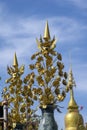 Stylized golden flowers against blue sky at temple, Chiang Rai, Thailand