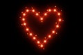 stylized illuminated Heart of light dots and stars on a black background Royalty Free Stock Photo