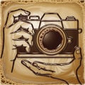 A stylized image of hands holding a camera, with a coffee cup resembling the camera lens, merges photography and coffee elements Royalty Free Stock Photo
