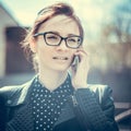 Stylized instagram colorized vintage fashion portrait of a young woman wearing glasses with beauty bokeh and small depth of f