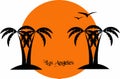 Palm trees silhouettes and seagulls and an orange sun at sunset with Los Angeles writing Royalty Free Stock Photo