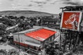 Stylized photo in black and white with red roof and Coca Cola advertising in city Matadi, Democratic Republic of Congo Royalty Free Stock Photo