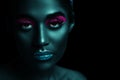 Stylized portrait of a beautiful girl with neon makeup