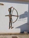 Stylized Representation of an Archer on a White Wall