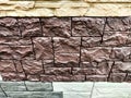 Stylized stone or brick plastic wall of different colors. Abstract Background, Texture, Pattern, frame, place for text Royalty Free Stock Photo
