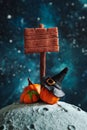 Stylized wooden signpost, witch hat and pumpkins on the moon Royalty Free Stock Photo