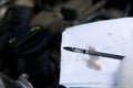 Stylus to check the engine oil is wiped with a white rag Royalty Free Stock Photo