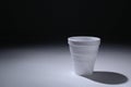 Styrofoam cup on black background with white light. Royalty Free Stock Photo