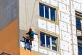 Styrofoam insulation of high-rise building. Rope access working. Concept of industrial alpinism