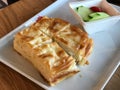 Su Boregi / Turkish Pastry Borek with tomatoes and cucumber served at restaurant.