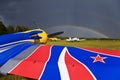 SU-26 sport airplane on the airfield. Rainbow over the sky.