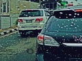 Suan Luang, THAILAND - 10 november 2018 : Traffic in rainy day on the road and rain drops on car window with tailing break light. Royalty Free Stock Photo