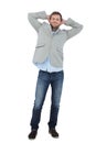 Suave man in a blazer with hands behind head looking at camera Royalty Free Stock Photo