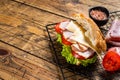 Sub sandwich with ham, cheese, tomato and Lettuce. Wooden background. Top view. Copy space Royalty Free Stock Photo