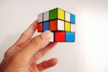 Man holding a rubik\'s cube on white background. 3x3 Rubik\'s cube