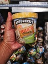 Subang Jaya, Malaysia - 20 February 2021 : Hand hold a BEN and JERRYS Milk and Cookies ice-cream for sell in the supermarket