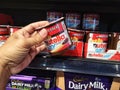 Subang Jaya, Malaysia - 20 February 2021 : Hand pick up a Nutella and Go chocolate cream with brot sticks at supermarket