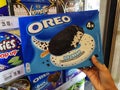 Subang Jaya,Malaysia-12 March 2022 : Hand hold a OREO ice cream with Oreo Cookie pieces box for sell in the supermarket.