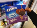 Subang Jaya,Malaysia-12 March 2022 : Hand hold a OREO Stick Sandwich ice cream box for sell in the supermarket.