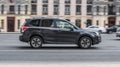 Subaru Forester fourth generation SJ at the test drive in city streets. Gray SUV in motion blur
