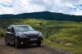 Subaru Forester stands on a dirt road in the mountains Royalty Free Stock Photo