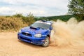 subaru impresa sti on race in a rally stage in drifting raises a lot of dust