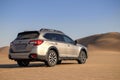 Subaru Outback standing in the middle of the Namib desert. Namibia