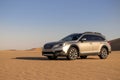Subaru Outback standing in the middle of the Namib desert. Namibia