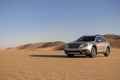 Subaru Outback standing in the middle of the Namib desert.