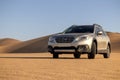 Subaru Outback standing in the middle of the Namib desert.