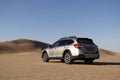 Subaru Outback standing in the middle of the Namib desert. Namibia