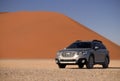 Subaru Outback stands in the middle of the Namib Desert, next to a sand dune of Sossusvlei Royalty Free Stock Photo