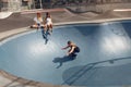 Subculture. Skater Friends At Skatepark. Group Of Hipsters In Casual Outfit With Modern Sport Equipment On Skating Ramp