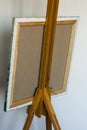 A subframe with a canvas on an easel, a view from behind