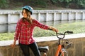 Subject ecological mode of transport bicycle. Beautiful young kasazy woman wearing a blue helmet and long hair poses standing next Royalty Free Stock Photo