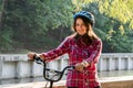 Subject ecological mode of transport bicycle. Beautiful young kasazy woman wearing a blue helmet and long hair poses standing next Royalty Free Stock Photo