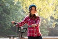 Subject ecological mode of transport bicycle. Beautiful young kasazy woman wearing a blue helmet and long hair poses standing next Royalty Free Stock Photo