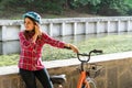 Subject ecological mode of transport bicycle. Beautiful young kasazy woman wearing a blue helmet and long hair poses standing next Royalty Free Stock Photo