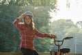 Subject ecological mode of transport bicycle. Beautiful young kasazy woman wearing a blue helmet and long hair poses standing next Royalty Free Stock Photo