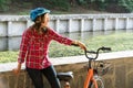 Subject ecological mode of transport bicycle. Beautiful young kasazy woman wearing a blue helmet and long hair poses standing next Royalty Free Stock Photo