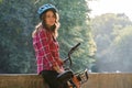 Subject ecological mode of transport bicycle. Beautiful young kasazy woman wearing a blue helmet and long hair poses standing next Royalty Free Stock Photo