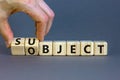 Subject and object symbol. Businessman turns a cube, changes the word subject to object. Beautiful grey table, grey background.