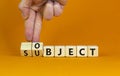 Subject and object symbol. Businessman turns a cube, changes the word subject to object. Beautiful orange table, orange background