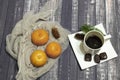Subject photography. tangerines, a Cup of coffee and chocolates on a dark background
