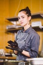 Subject profession and cooking pastry. young Caucasian woman with tattoo of pastry chef in kitchen of restaurant preparing round Royalty Free Stock Photo