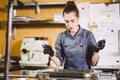 Subject profession and cooking pastry. young Caucasian woman with tattoo of pastry chef in kitchen of restaurant preparing round Royalty Free Stock Photo