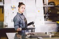 Subject profession and cooking pastry. young Caucasian woman with tattoo of pastry chef in kitchen of restaurant preparing round Royalty Free Stock Photo