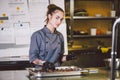 Subject profession and cooking pastry. young Caucasian woman with tattoo of pastry chef in kitchen of restaurant preparing round