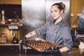 Subject profession and cooking pastry. young Caucasian woman with tattoo of pastry chef in kitchen of restaurant preparing round