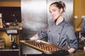 Subject profession and cooking pastry. young Caucasian woman with tattoo of pastry chef in kitchen of restaurant preparing round Royalty Free Stock Photo